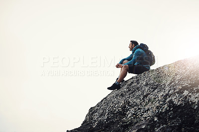 Buy stock photo Full length shot of a middle aged man sitting on the edge off a cliff