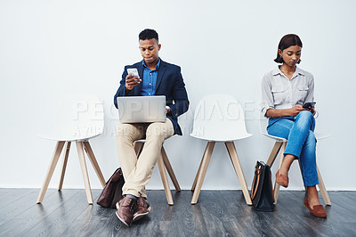 Buy stock photo Phone, laptop and people in interview waiting room and search the internet, web or website sitting on chairs. Internship, work and young employees texting or typing online ready for a new job