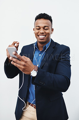 Buy stock photo Phone, music and businessman with earphones in studio for streaming audio, track or podcast on white background. Smartphone, playlist and African entrepreneur with online album, radio or video call