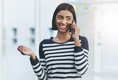 Buy stock photo Shot of a young businesswoman making phone calls in her office