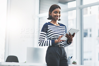 Buy stock photo Portrait of a young businesswoman using a digital tablet in her office