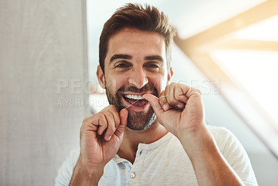 Buy stock photo Dental floss, teeth and smile with portrait of man in bathroom for cleaning, morning and oral hygiene. Happy, cosmetics and health with face of person flossing at home for self care, breath and mouth