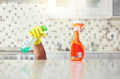 Buy stock photo Cropped shot of an unrecognizable young man cleaning his home while hiding under the kitchen counter