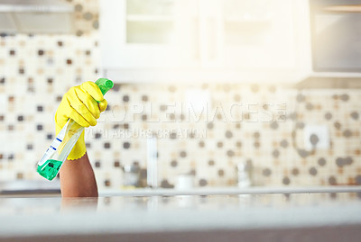 Buy stock photo Cropped shot of an unrecognizable young man cleaning his home while hiding under the kitchen counter