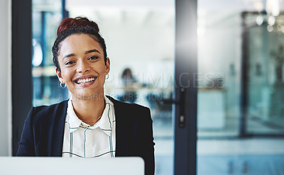 Buy stock photo Shot of a young businesswoman using a laptop in a modern office
