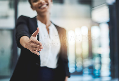 Buy stock photo Cropped shot of a young businesswoman extending her arm for a handshake
