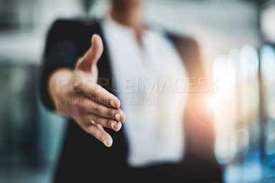 Buy stock photo Cropped shot of an unidentifiable businesswoman extending her arm for a handshake