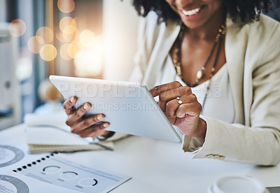 Buy stock photo Shot of an unrecognizable businesswoman using her digital tablet at her office desk