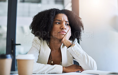 Buy stock photo Shot of a young businesswoman looking stressed and frustrated at her office desk