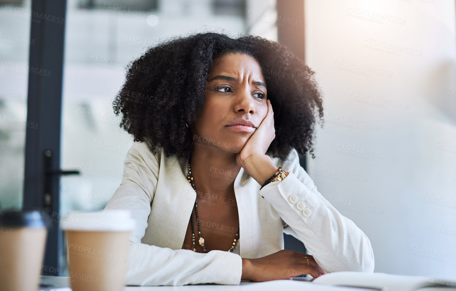 Buy stock photo Shot of a young businesswoman looking stressed and frustrated at her office desk