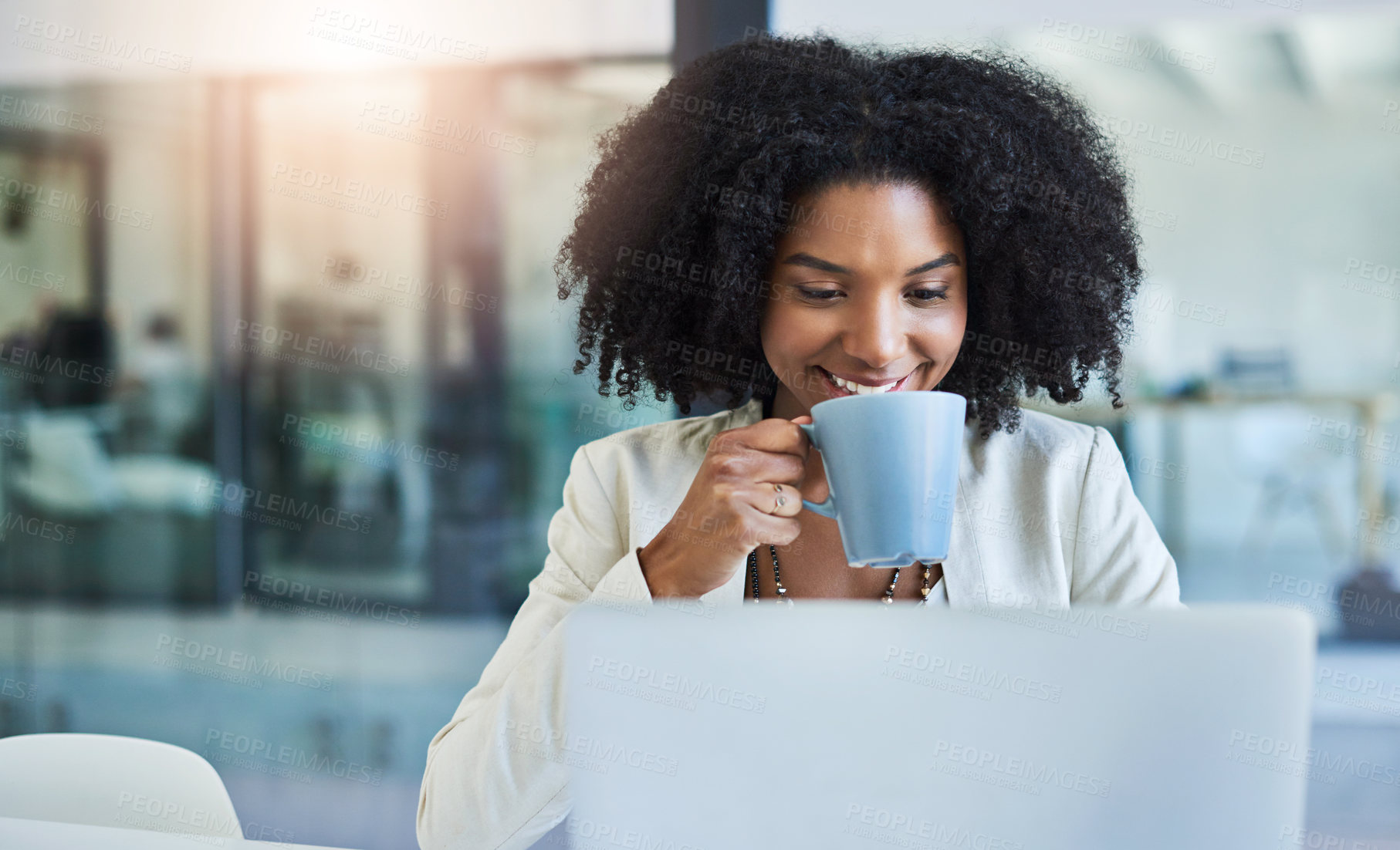 Buy stock photo Shot of a young businesswoman having a cup of coffee while doing some work at her office desk