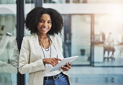 Buy stock photo Portrait of a young businesswoman smiling and holding a digital tablet in her office