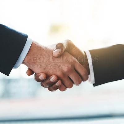 Buy stock photo Cropped shot of two unrecognizable businessmen shaking hands in an office