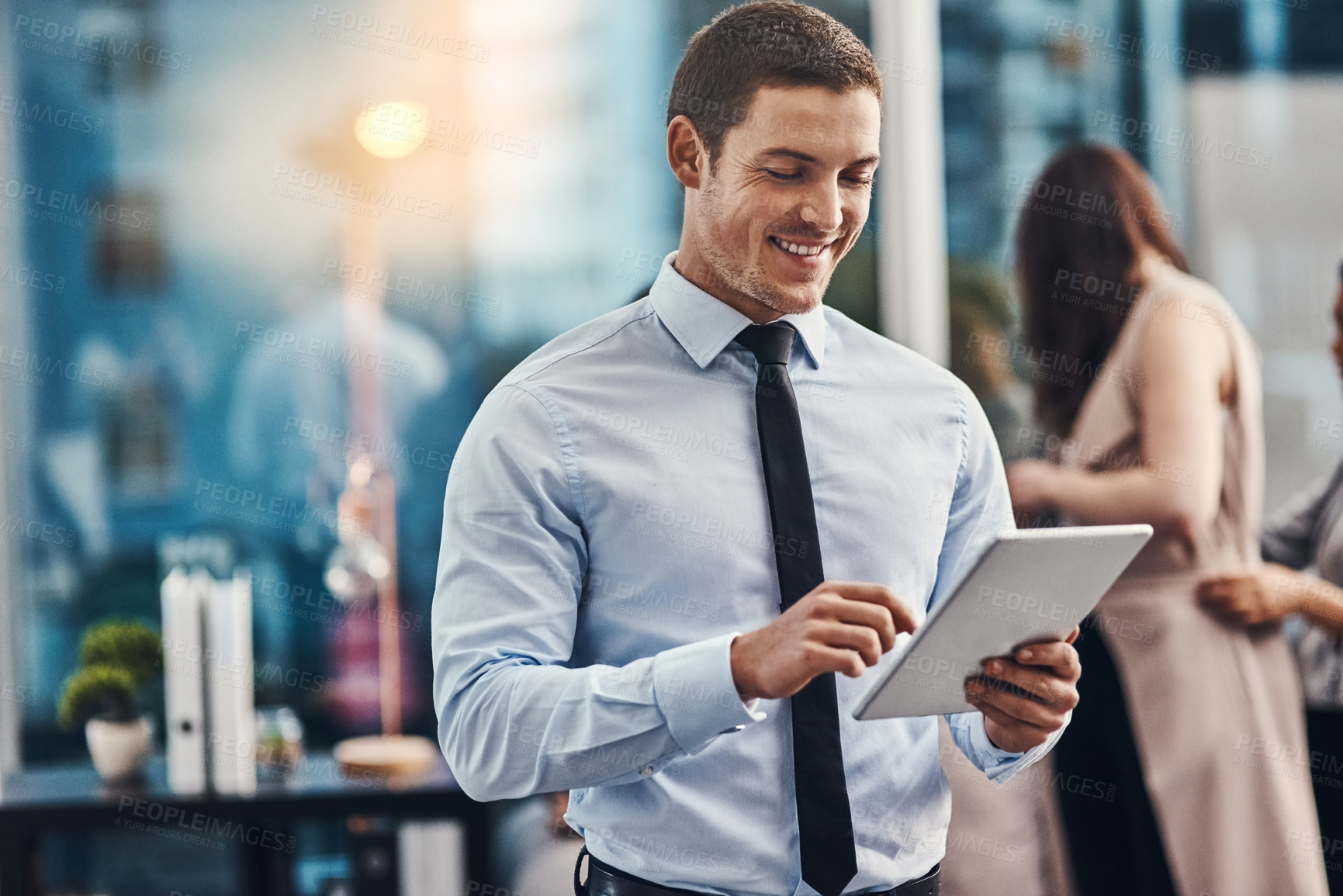 Buy stock photo Happy, businessman and browsing with tablet at office for research, trading or reading news. Young man or employee scrolling with smile on technology for online web, career or job search at workplace