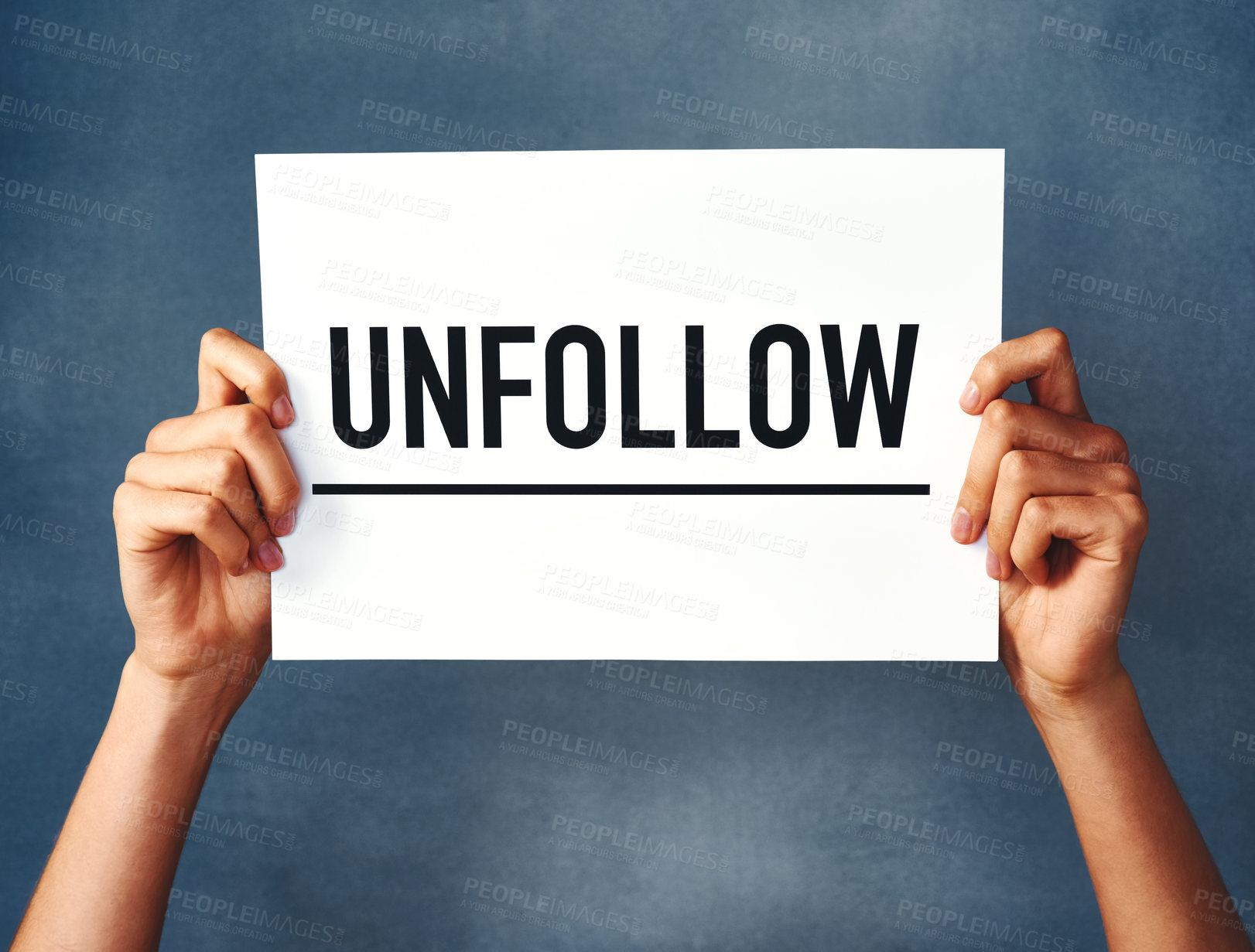 Buy stock photo Studio shot of an woman holding a sign that says “unfollow” against a blue background