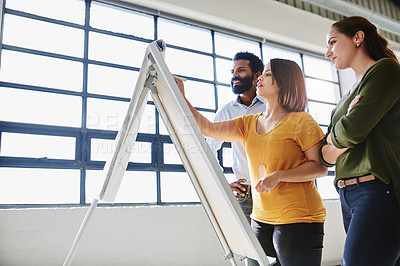 Buy stock photo Cropped shot of a group of businesspeople brainstorming together in an office