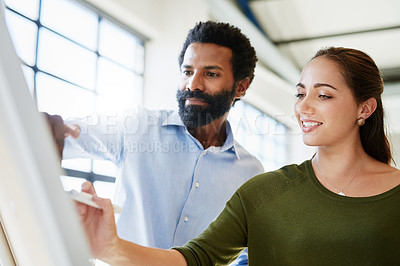 Buy stock photo Cropped shot of two businesspeople brainstorming together in an office