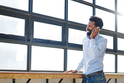 Buy stock photo Window, smile and phone call with a business man thinking about the future success of his company in the office. Happy, mindset and communication with a male employee chatting on his mobile at work