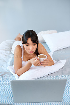 Buy stock photo Asian woman, home and lying in bed with laptop for streaming movies and series on website. Female person, day off and technology for online entertainment, videos and relax with coffee in apartment