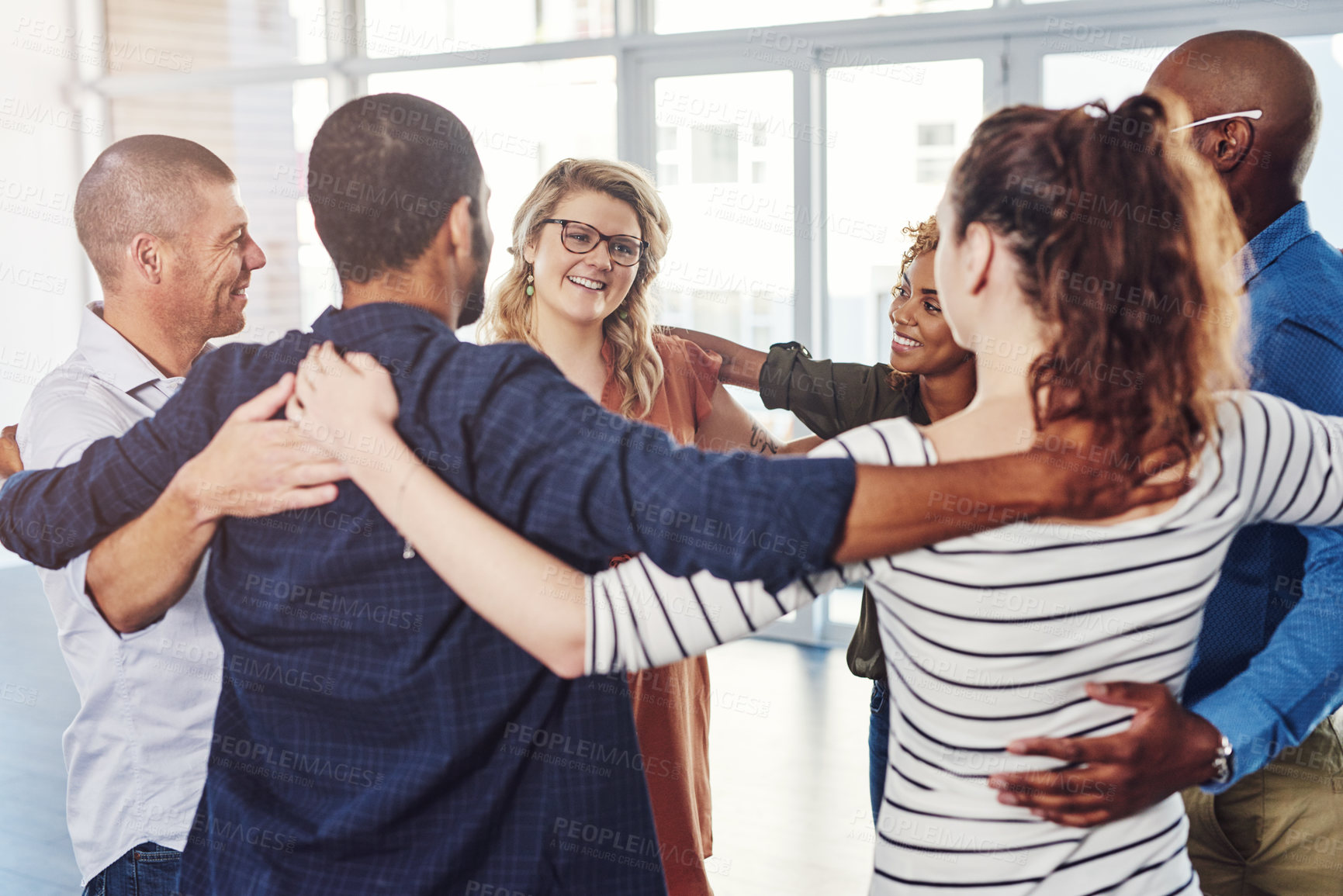 Buy stock photo Shot of a group of people standing in a circle together