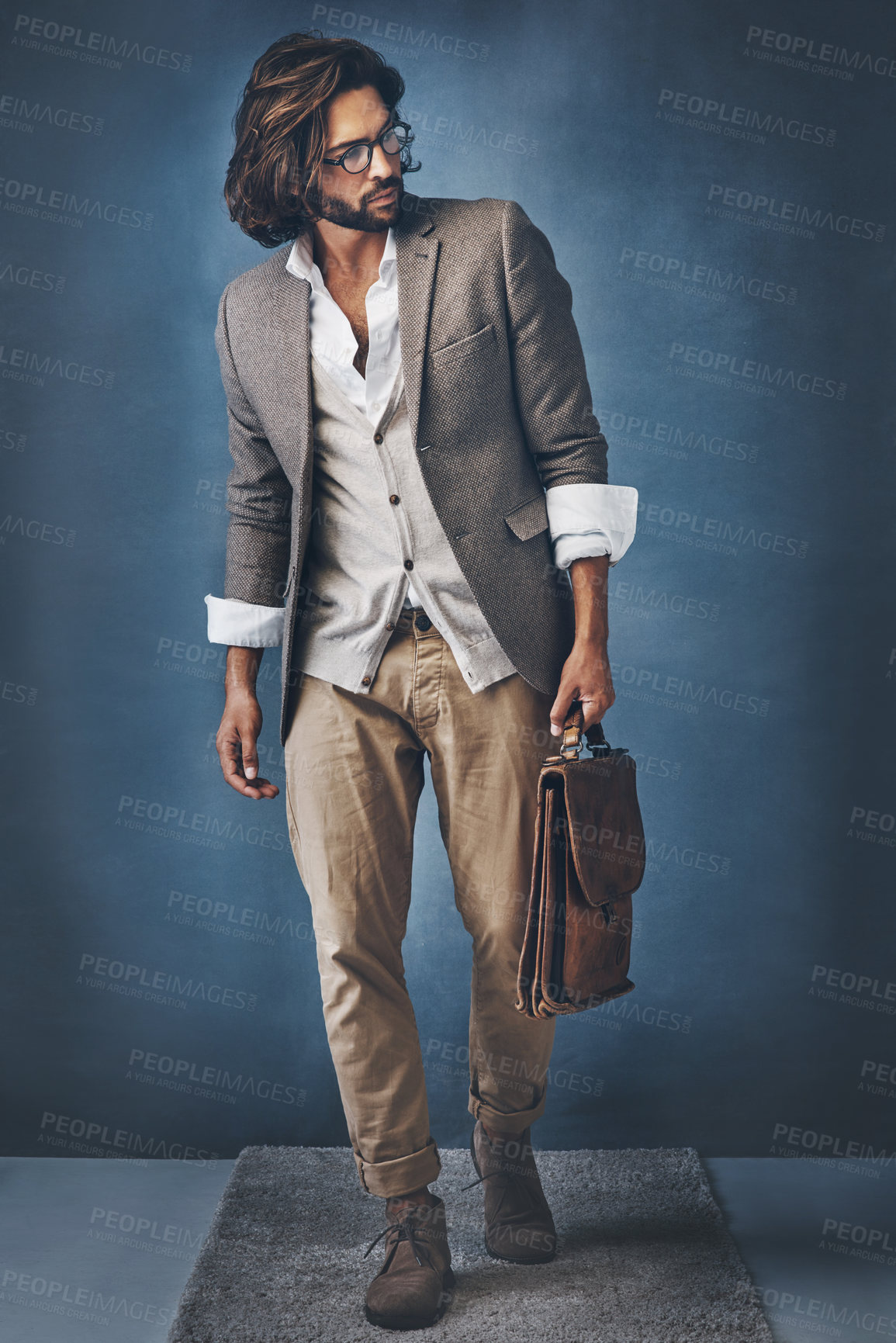 Buy stock photo Studio shot of a handsome young man posing against a grey background