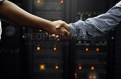 Buy stock photo Cropped shot of two unrecognizable men shaking hands in front of a server in a data center