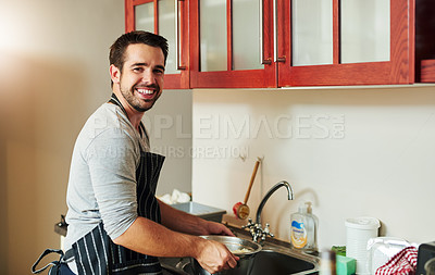 Buy stock photo Cropped portrait of a handsome young man draining pasta at home