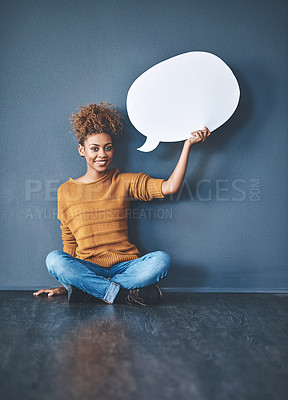 Buy stock photo Studio shot of a young woman holding a speech bubble against a grey background