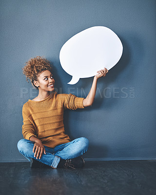Buy stock photo Smiling woman holding a blank white speech bubble and copyspace. Lady looking at an empty cut out to announce a sale or marketing concept. Female voice opinion on a social media chat display