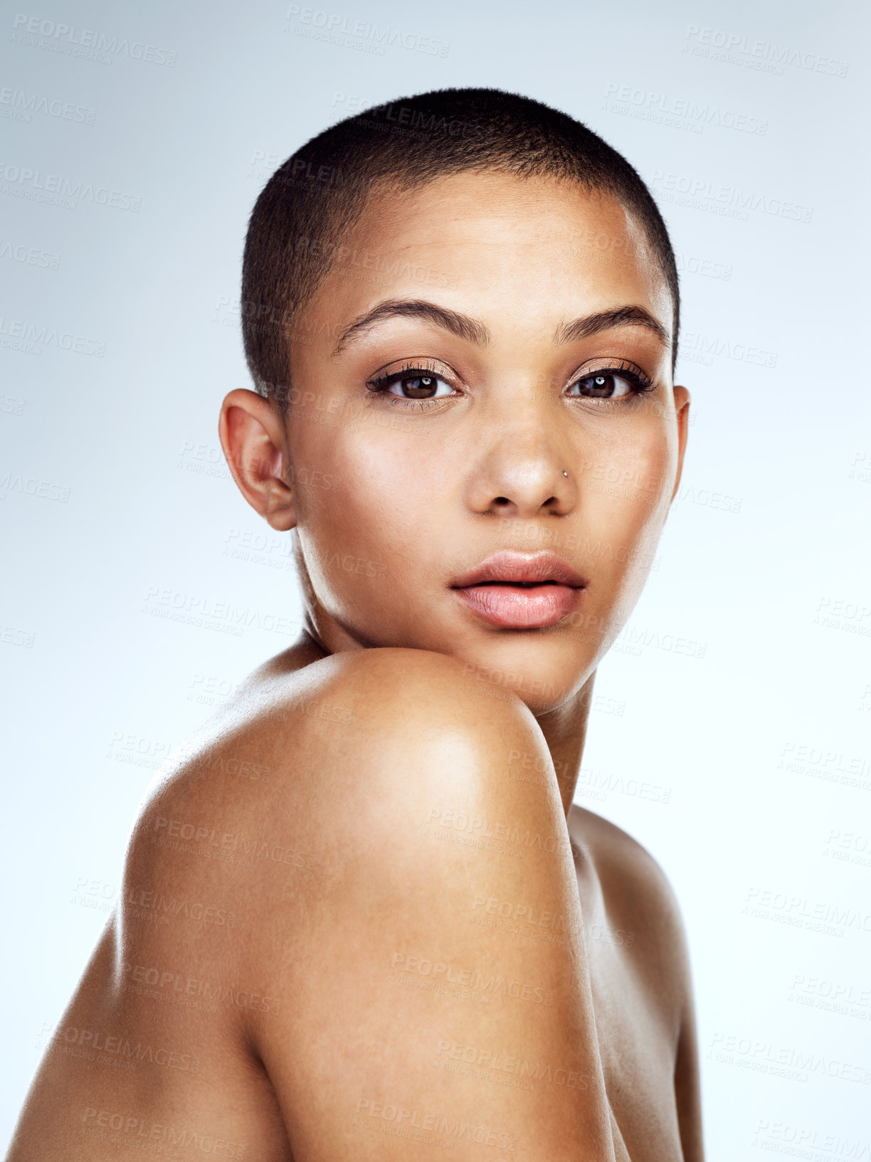 Buy stock photo Beauty, serious and portrait with shoulder of young woman in studio on blue background for wellness. Aesthetic, cosmetics and natural with face of model for dermatology, skincare glow or vitamin c