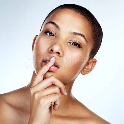 Buy stock photo Studio shot of a beautiful young woman posing with her finger on her lips