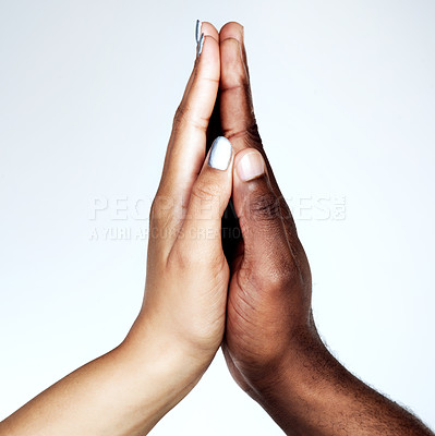 Buy stock photo Studio shot of two unrecognizable people holding their hands together against a grey background