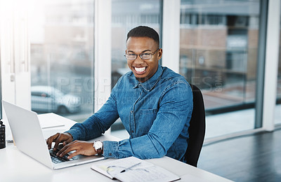 Buy stock photo Portrait, smile and businessman in modern office with laptop, paperwork and pride at desk. Black man, happiness and technology in workplace for internship, journalist and research for startup company