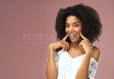 Buy stock photo Happy, woman and hand on face for dental care, oral hygiene and mockup space isolated in studio. Excited, female person and smile with finger on cheek for teeth treatment, transformation and wellness