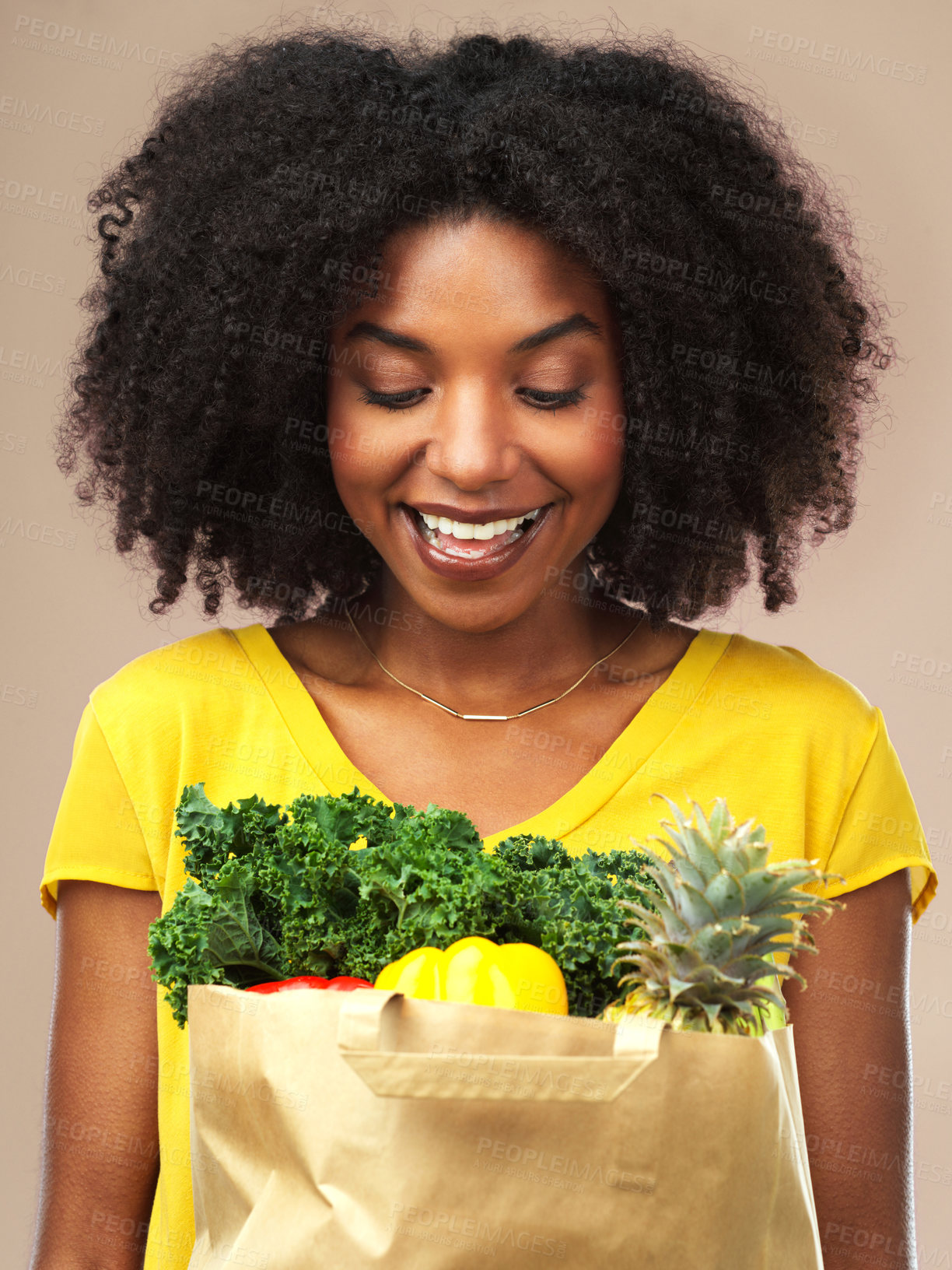 Buy stock photo Black woman, grocery or package of vegetables and fruit in studio background smiling for eating healthy or delivery. Female person, happy and wellness food in bag for organic shopping and nutrition