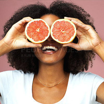 Buy stock photo Grapefruit, happy and black woman covering her eyes in studio isolated on a pink background. Funny, fruit and African female model with vegan nutrition, vitamin c or healthy diet, food and wellness.