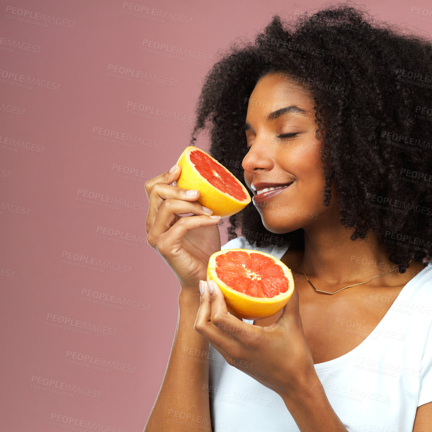 Buy stock photo Studio, woman and smell grapefruit for health, wellness and vegan nutrition with mockup space. Person, vitamin C and hydration of fruit for diet, citrus and isolated by pink background with smile 