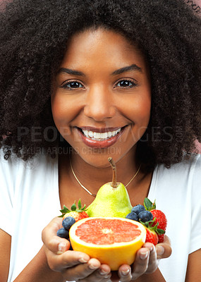 Buy stock photo Happy woman, portrait and fruit in studio for health, wellness and vegan diet in morning. Female nutritionist, food and hands with smile for nutrition, self care and vitamin intake for wellbeing