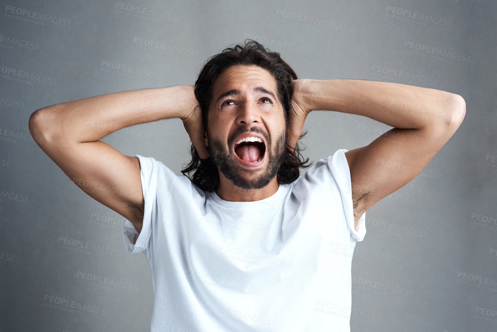 Buy stock photo Studio shot of a young man screaming against a grey background