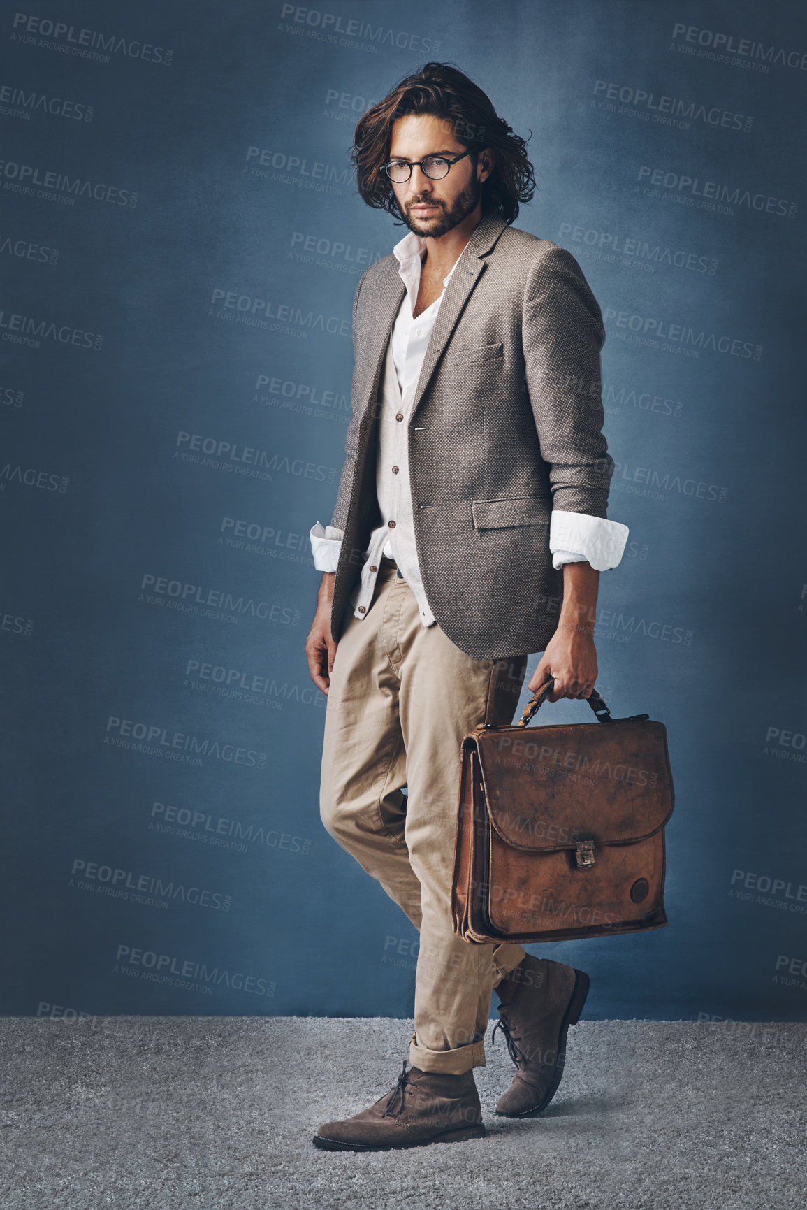 Buy stock photo Fashion, man and studio for creative walk, suitcase and bag for business commute on background. Smart casual, professional and trendy clothes with style, travel and luggage accessory for career