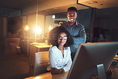 Buy stock photo Portrait of two businesspeople working together on a computer in an office at night