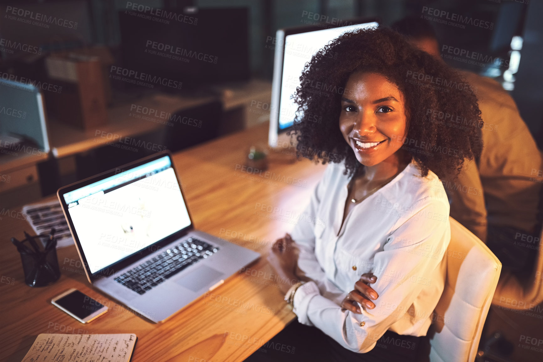 Buy stock photo Portrait of a young businesswoman working on a laptop in an office at night