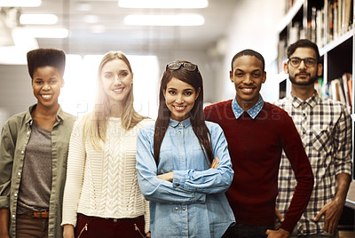 Buy stock photo Portrait of a group of university students standing together in the library on campus