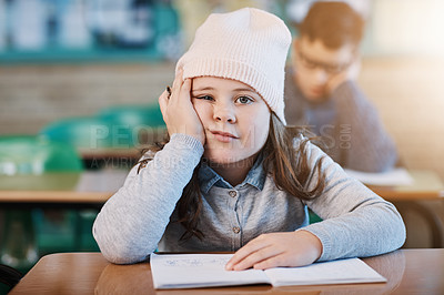 Buy stock photo Cropped portrait of an elementary school girl looking bored while sitting in the classroom