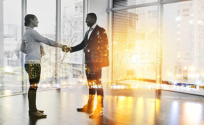 Buy stock photo Full length shot of two businesspeople shaking hands in an office