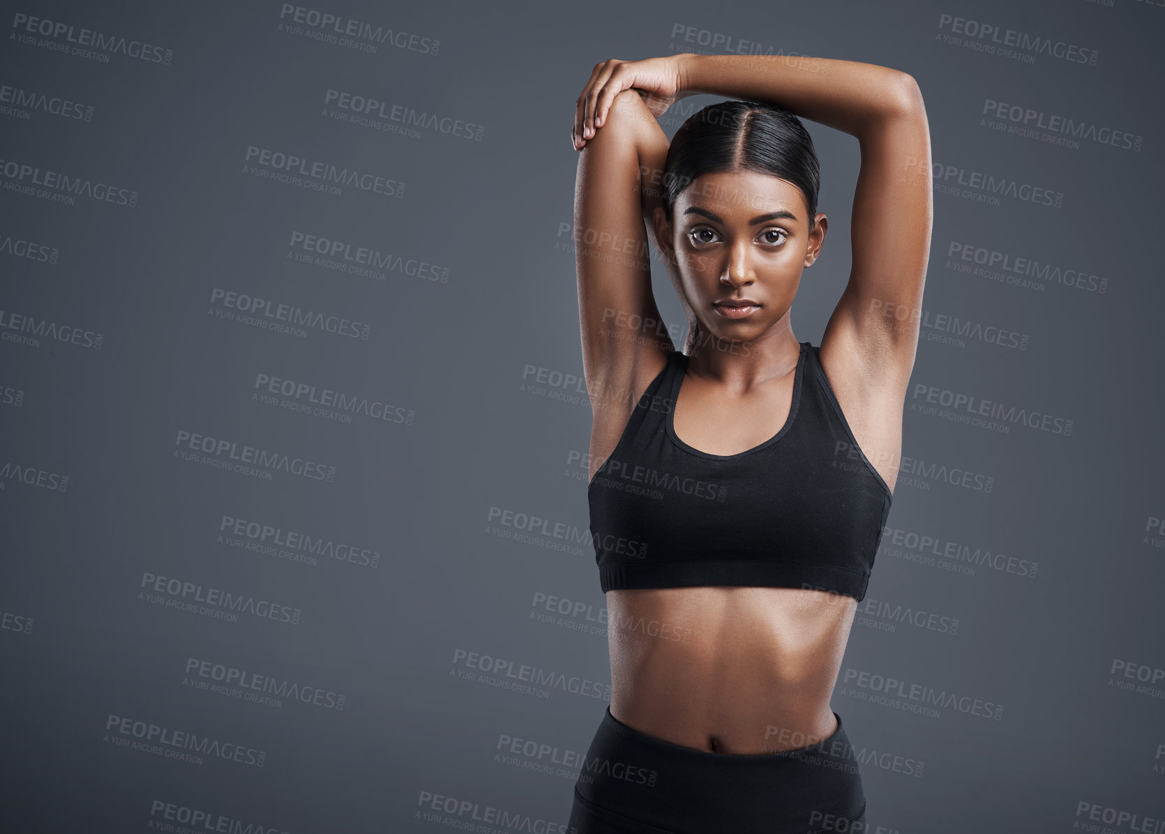 Buy stock photo Portrait, mock up and stretching with an athlete woman in studio on a gray background for fitness or health. Exercise, workout or getting ready with an attractive young female model training her body