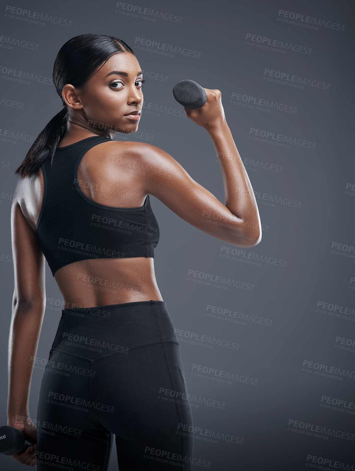 Buy stock photo Woman, dumbbells and workout for fitness in studio on grey background for health, muscles and sportswear. Female person, exercise and committed for wellbeing with weights for training and self care