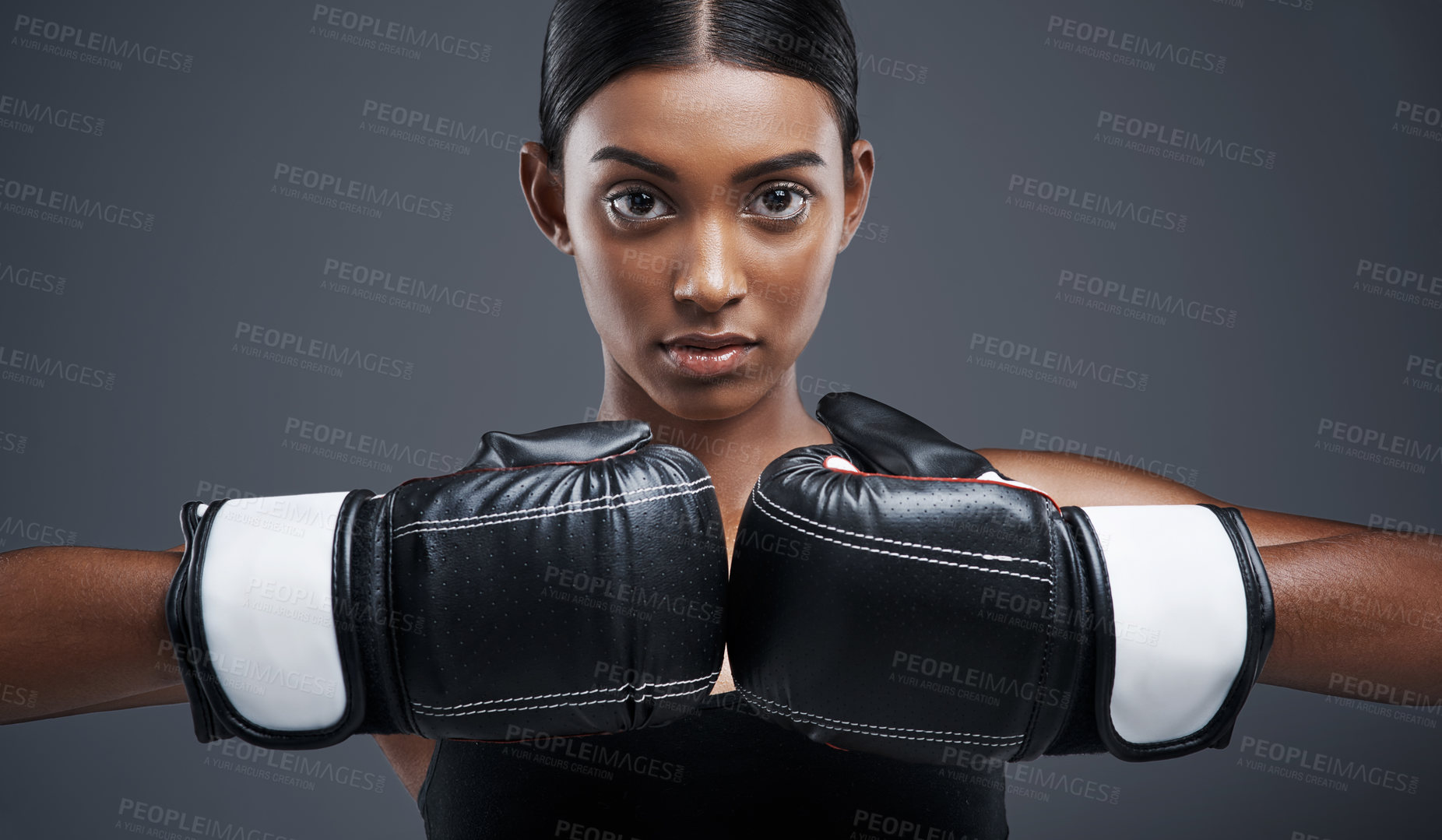 Buy stock photo Portrait, boxing gloves and Indian woman in studio with fists, combat and training for fitness. Self defence, boxer or mma fighter for performance, workout and muay thai and cardio or impact exercise