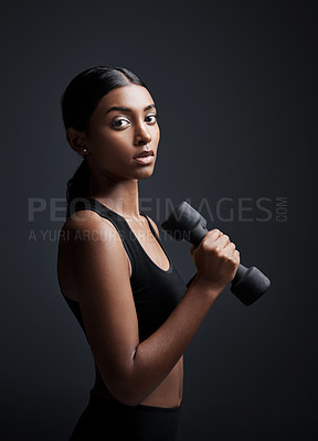 Buy stock photo Portrait, serious and woman with dumbbell for exercise in studio isolated on black background. Strong, bodybuilder and female athlete with weight for muscle, strength or fitness, workout or training.