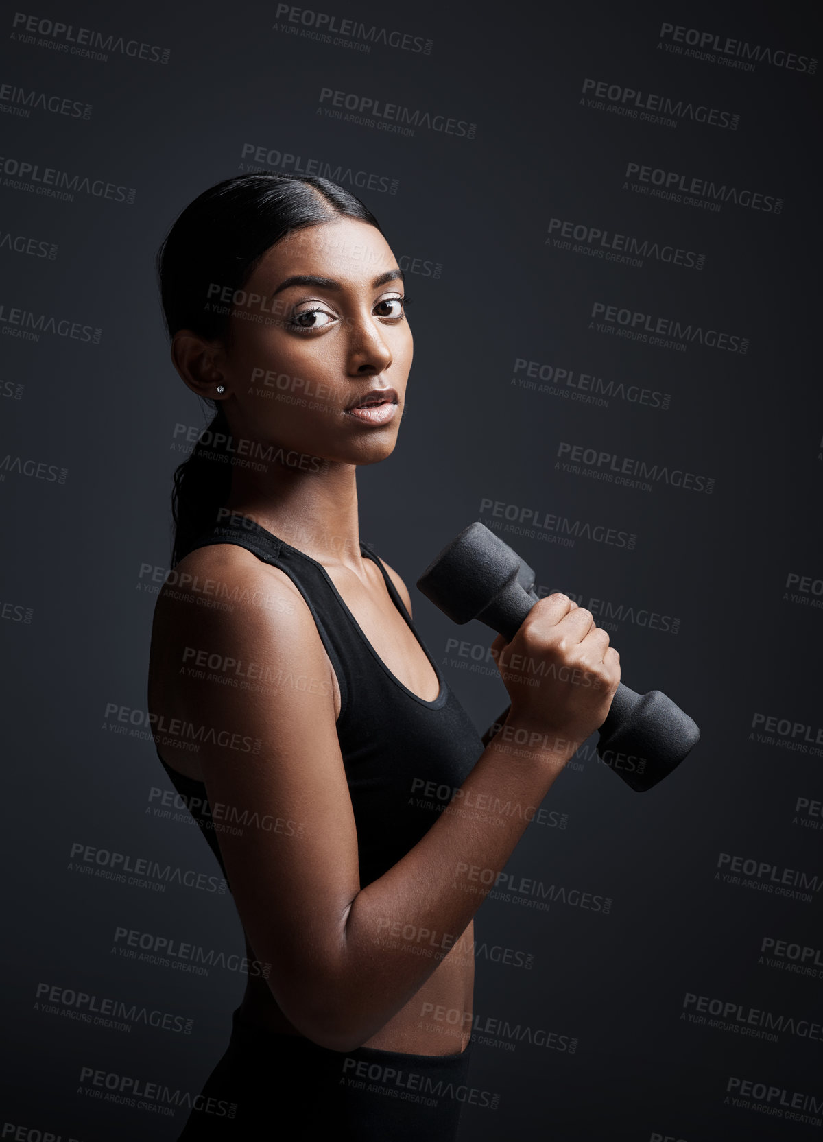 Buy stock photo Portrait, serious and woman with dumbbell for exercise in studio isolated on black background. Strong, bodybuilder and female athlete with weight for muscle, strength or fitness, workout or training.